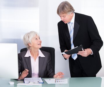 bookkeeper conferring at desk with accountant